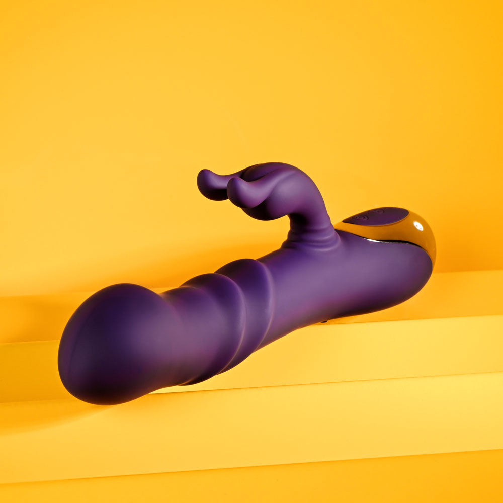 Side view of a Purple Rabbit vibrator on a yellow background, showing the tip for inside stimulation | Flirty Bay Adult Store australia and bondage tools