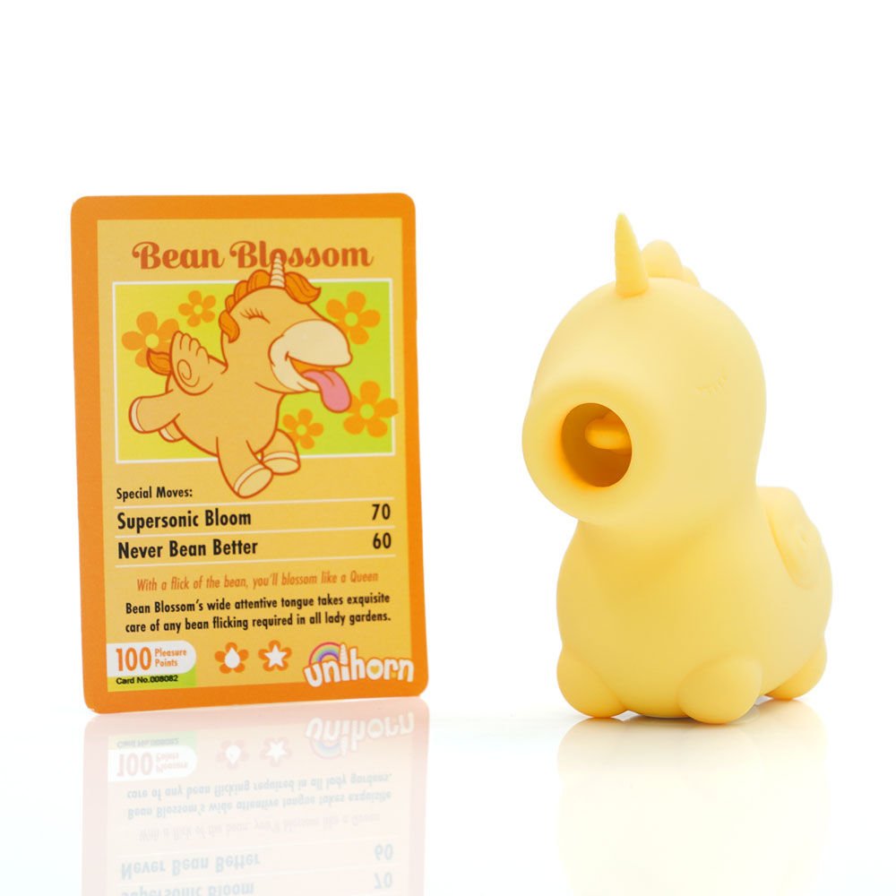 ellow Unihorn Bean Blossom clitoral stimulator, front view with playing card on clean white background. | Flirty bay adult store and lingerie store