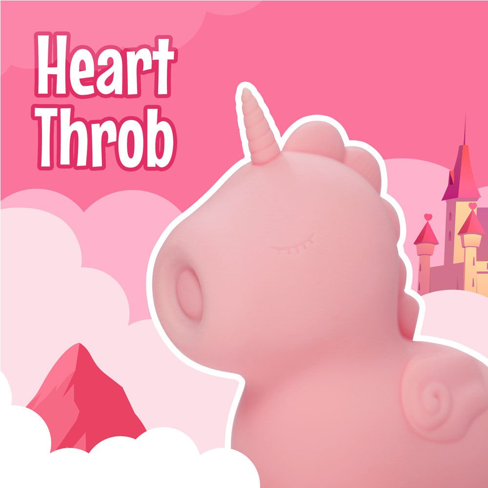 Side view of the Unihorn Heart Throb pulsing clitoral stimulator, placed in a princess-themed design with a castle, set against varying shades of pink  | Flirty Bay adult store nd lingerie store