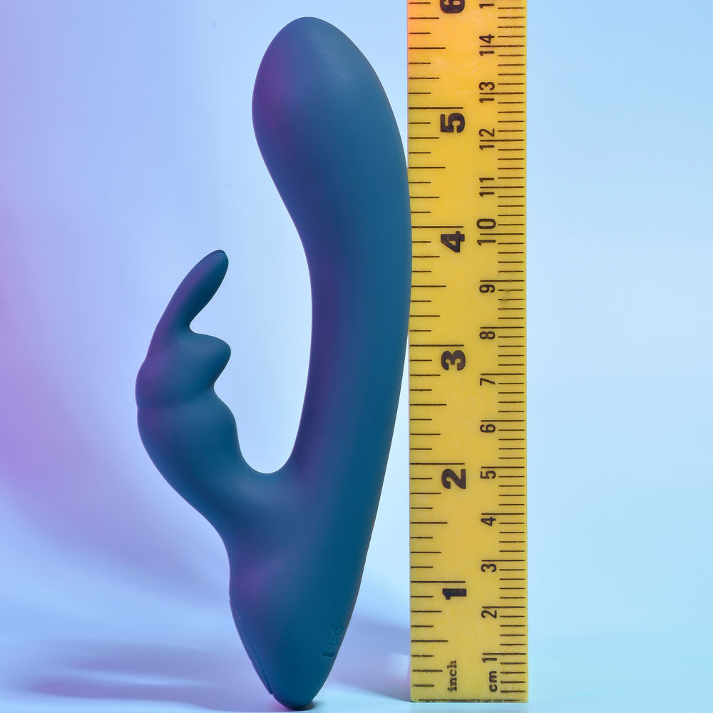Side view of the packaging and teal Playboy Pleasure Lil Rabbit vibrator, with a ruler for size references on a blue background | Flirty Bay adult store and lingerie store