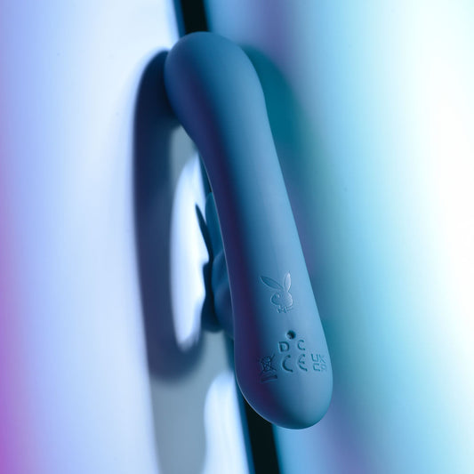 Top Back view of the packaging and teal Playboy Pleasure Lil Rabbit vibrator on a blue background | Flirty Bay adult store and lingerie store