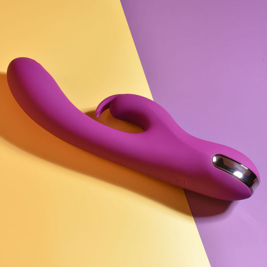 Top Side view of the Playboy Pleasure Thumpur thumping rabbit vibrator, on a purple and yellow background | Flirty Bay adult store and lingerie store