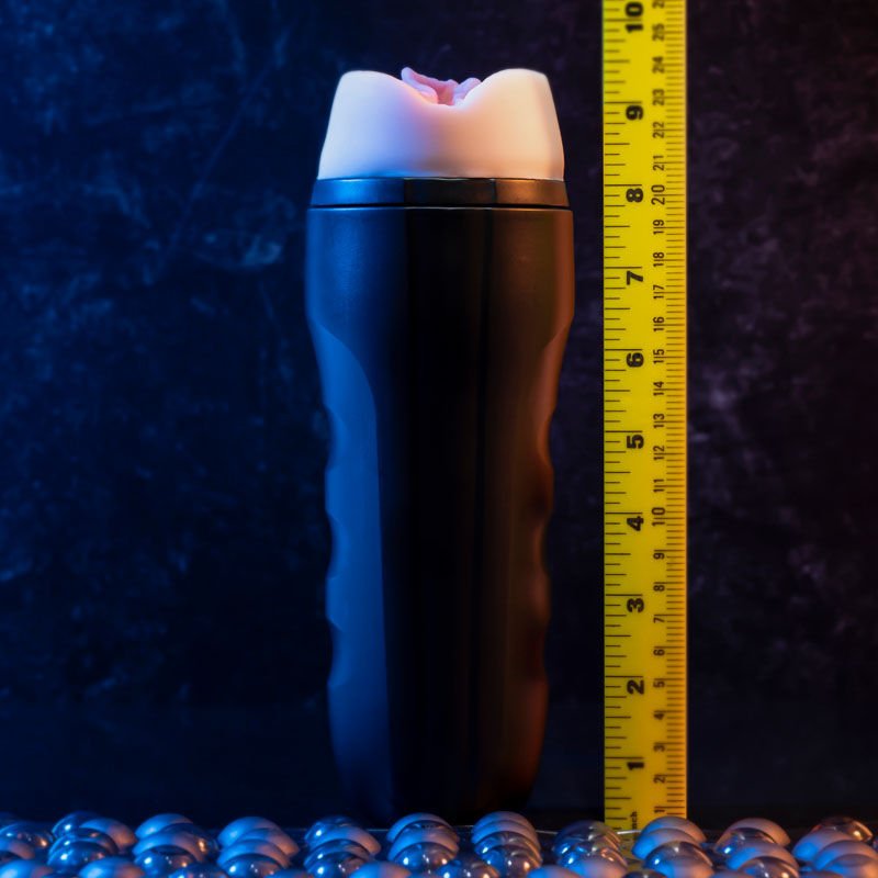 Front view of the Zero Tolerance Grip It Light pocket pussy with a ruler for size reference, on a warm purple background | Flirty Bay adult store Perth