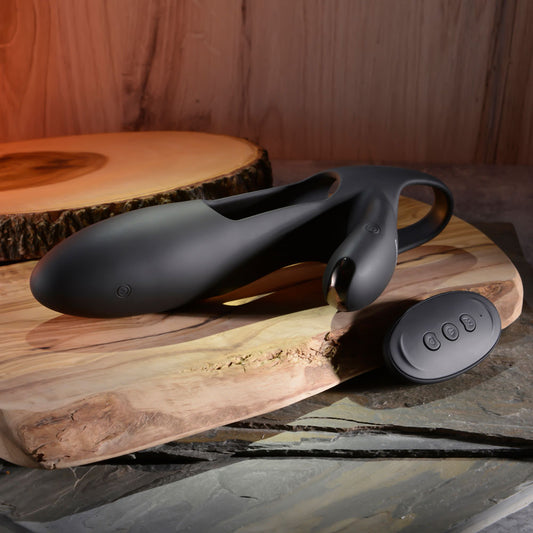 One top view of the Zero Tolerance - Nautilus - Rechargeable Vibrating Penis Extender with its remote control, on a wooden background | Flirty Bay, male sex toys in Perth Australia