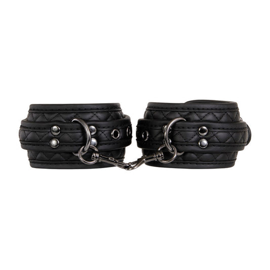 Beginner bondage kit by Adam & Eve with wrist cuffs, ankle cuffs, blindfold, and paddle in padded black vegan leather, focus on cuffs | Flirty bay online adult store, adult toys and lingerie