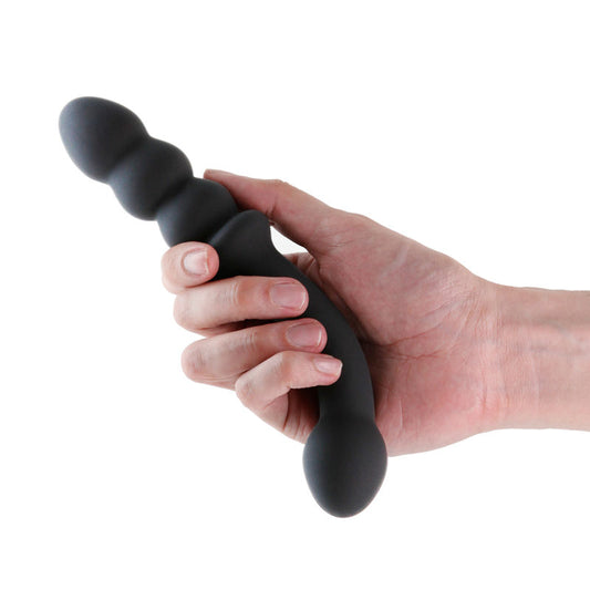 Side view of the black Renegade Duel vibrating anal beads held in a hand, demonstrating size and flexible silicone texture | Flirty Bay, anal plug adult store Australia