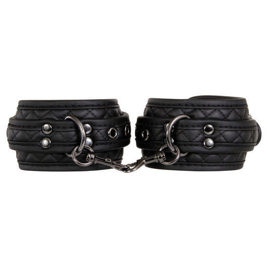 7-piece advanced bondage set in black diamond-stitched vegan leather by Adam & Eve with cuffs, collar, ball gag, leash, blindfold, paddle, and hogtie, focus on handcuffs | Flirty bay online adult store, adult toys and lingerie