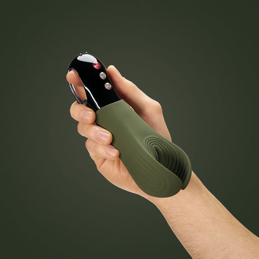 Green Fun Factory Manta Moss male masturbator held in a man’s hand on green background | Flirty Bay Adult Store and Strokers in Perth Australia