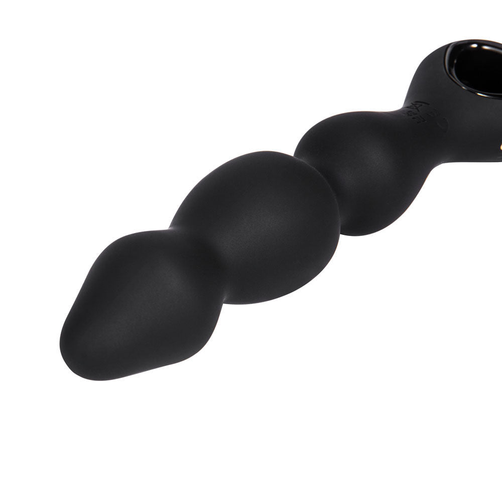 Close-up of the tip of the Maia Hudson vibrating black anal beads in black silicone on a clean white background | Flirty Bay, anal plug adult store Australia