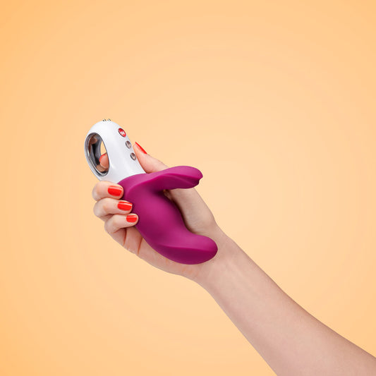 Miss BI rabbit vibrator held in hand against a beige background, highlighting ergonomic design and size | Flirty Bay, anal plug adult store Australia