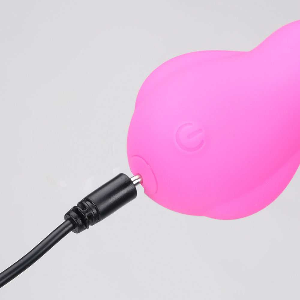 Top view close-up of the pink Maia Bri rechargeable vibrating bunny bullet showing the charger point on a white background | Flirty Bay, sex toys Australia