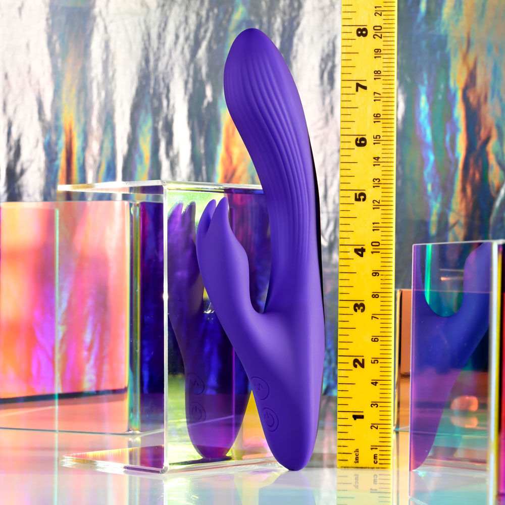 Front view of Selopa Poseable Bunny Rabbit Vibrator with ruler for measurement in a disco decor | Flirty Bay, sex toys Australia