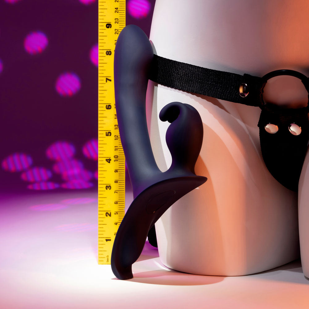 Close-up of dildo with O-ring on black harness on the mannequin, ruler showing real size on disco background | Flirty Bay adult store Australia