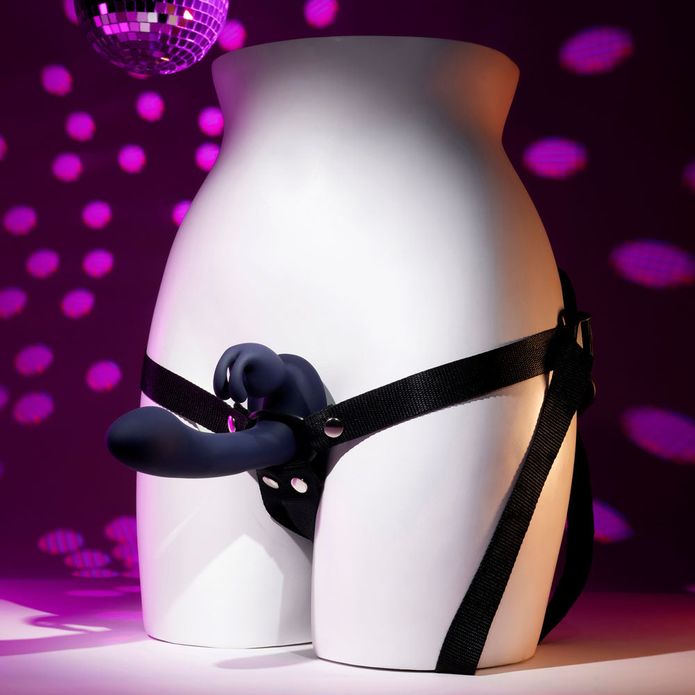 Side view of vibrating strap-on on mannequin with purple and pink decor background | Flirty Bay, couple sex toys adult store Australia
