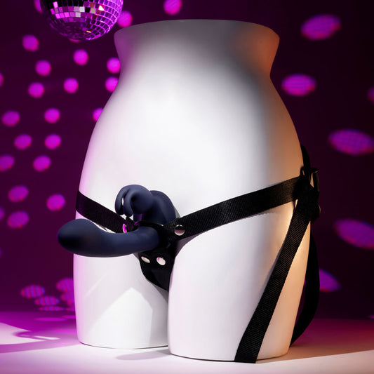 Side view of vibrating strap-on on mannequin with purple and pink decor background | Flirty Bay, couple sex toys adult store Australia