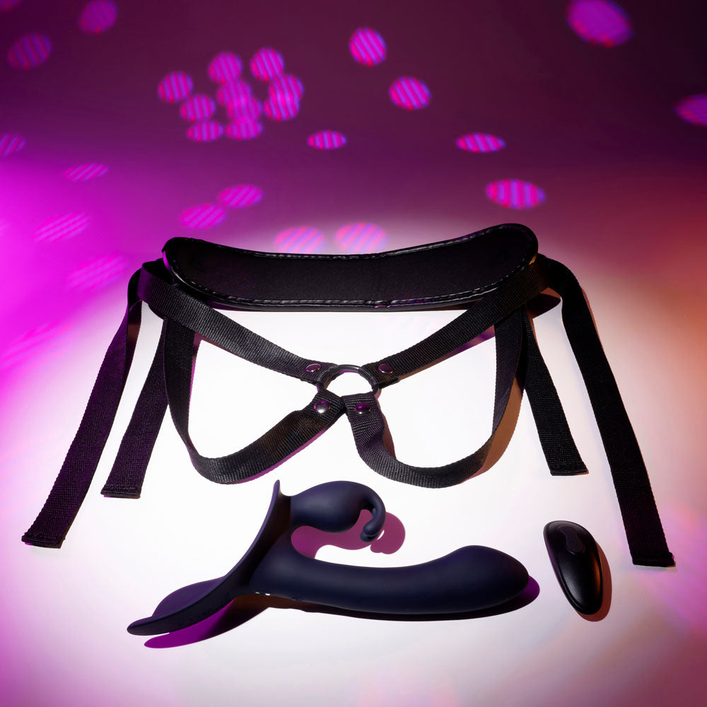 Top view of strap-on on floor with pink and purple disco background | Flirty Bay adult store Australia