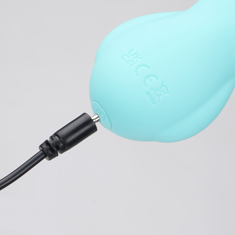 Top view close-up of the teal Maia Bri rechargeable vibrating bunny bullet showing the charger point on a white background | Flirty Bay, sex toys Australia