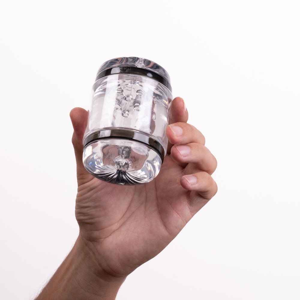 Side view of the Maia Anson Hard Cup Stroker masturbator held in a hand, showing size and design on a white background | Flirty Bay adult store Perth