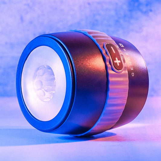 Side view of the Gender X Barrel Of Fun Stroker Male Masturbator displayed on a blue decorative background, showcasing the ergonomic shape and size. | Flirty Bay adult store Perth