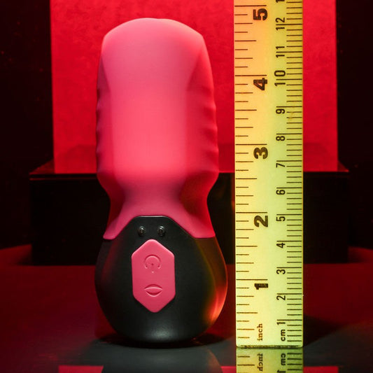 Front view of the Gender X Body Kisses Stroker Male Masturbator with a ruler for size reference, shown on a pink and black decorative background. | Flirty Bay adult store Perth