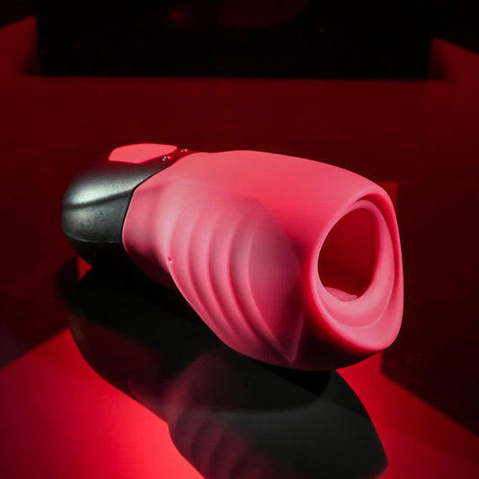 Side view of the Gender X Body Kisses Stroker Male Masturbator focusing on the realistic entry opening, displayed on a pink and black decorative background. | Flirty Bay adult store Perth