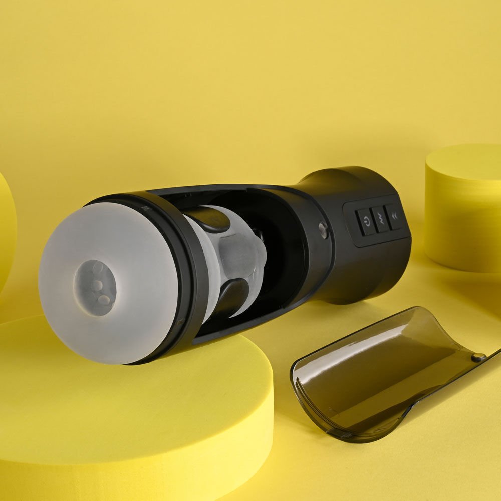 Side view of the Playboy Pleasure End Game vibrating stroker opened to display the motor inside, on a yellow background | Flirty Bay adult store Perth