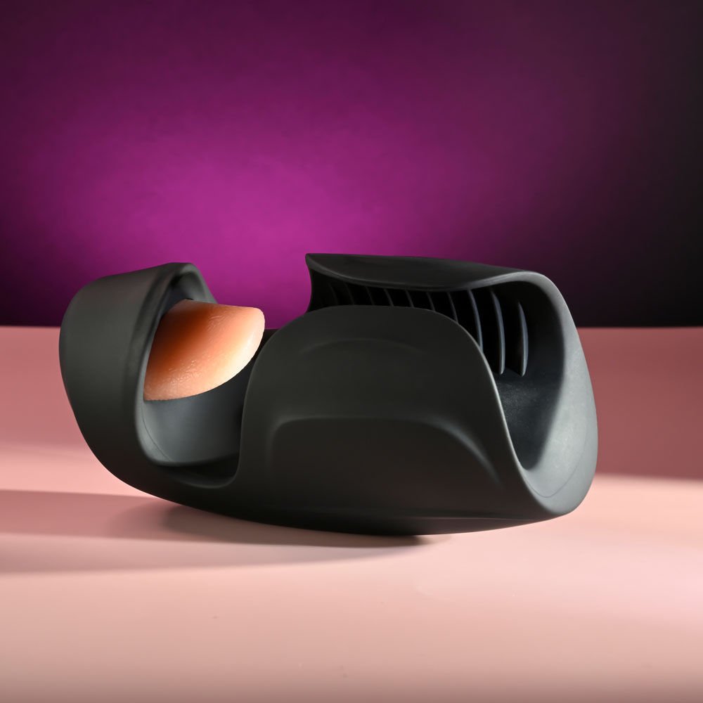 Zero Tolerance Lick the Tip vibrating male masturbator lying on the floor, showing the bottom of the toy for base and design detail, set against a purple and pink background | Flirty Bay adult store Perth