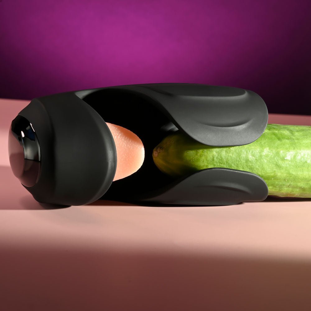 Zero Tolerance Lick the Tip vibrating masturbator with a cucumber inserted to demonstrate size and usage, shown from the front view, on a purple and pink background | Flirty Bay adult store Perth