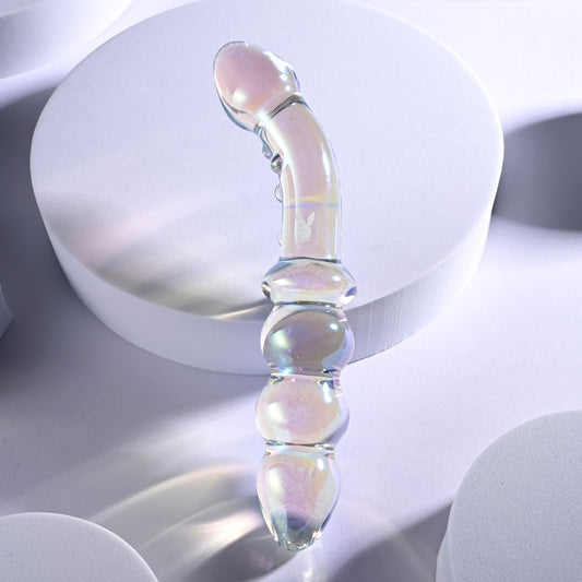 Top view of the dual-ended glass anal beads highlighting the smooth finish and curved shaft on a grey light pink background | Flirty Bay, anal plug adult store Australia